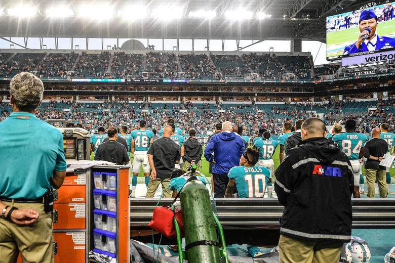 MIAMI, FL - AUGUST 25: Albert Wilson #15 and Kenny Stills #10 of the Miami Dolphins sit on the bench during the National Anthem before a preseason game against the Baltimore Ravens at Hard Rock Stadium on August 25, 2018 in Miami, Florida. (Photo by Mark Brown/Getty Images)